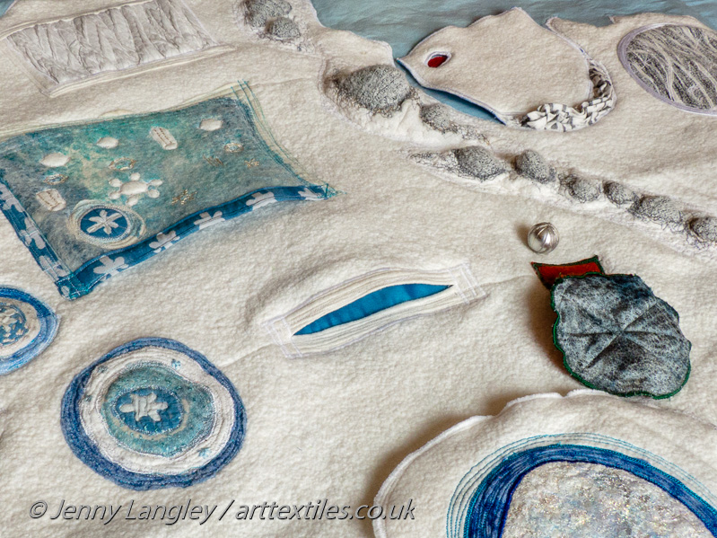 At the centre, a flash of blue from the deep pocket representing the sub-glacial Lake Vostok.