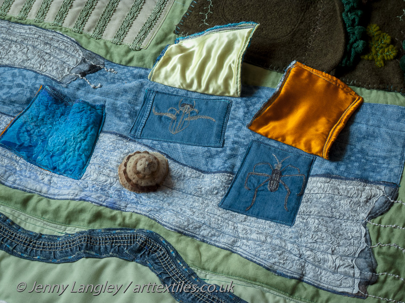 Flaps lifted up to reveal a pond skater and waterboatman, which live in the lake.