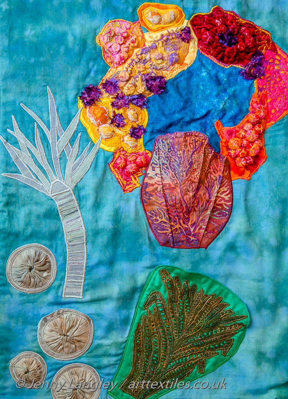 A coral atoll with a fossilised tree fern, crinoid and mushroom corals.